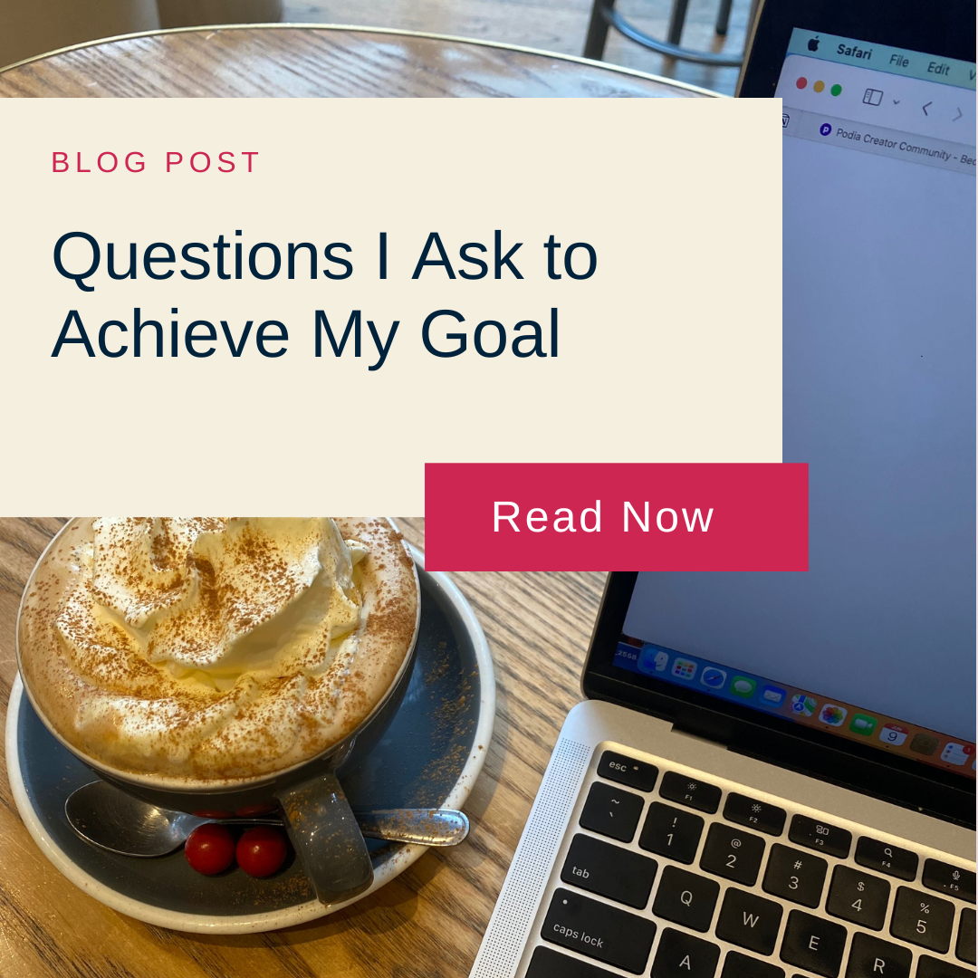 A steaming cappuccino with whipped cream and a laptop on a wooden table. Text overlay reads "Blog Post: Questions I Ask to Achieve My Goal. Read Now."