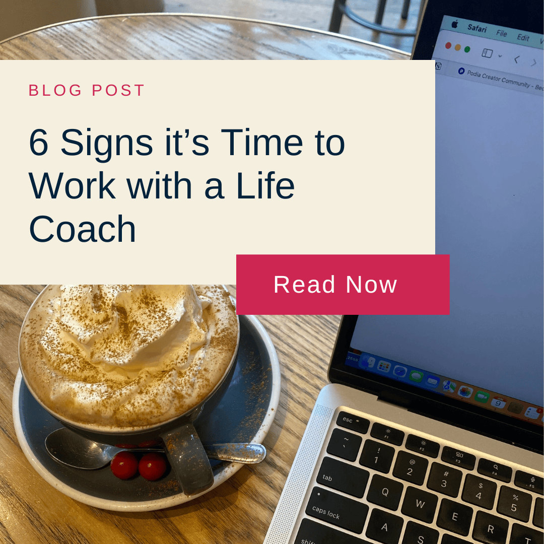 Blog post image showing a cappuccino with whipped cream and a laptop on a wooden table. Overlay text reads "6 Signs it’s Time to Work with a Life Coach."